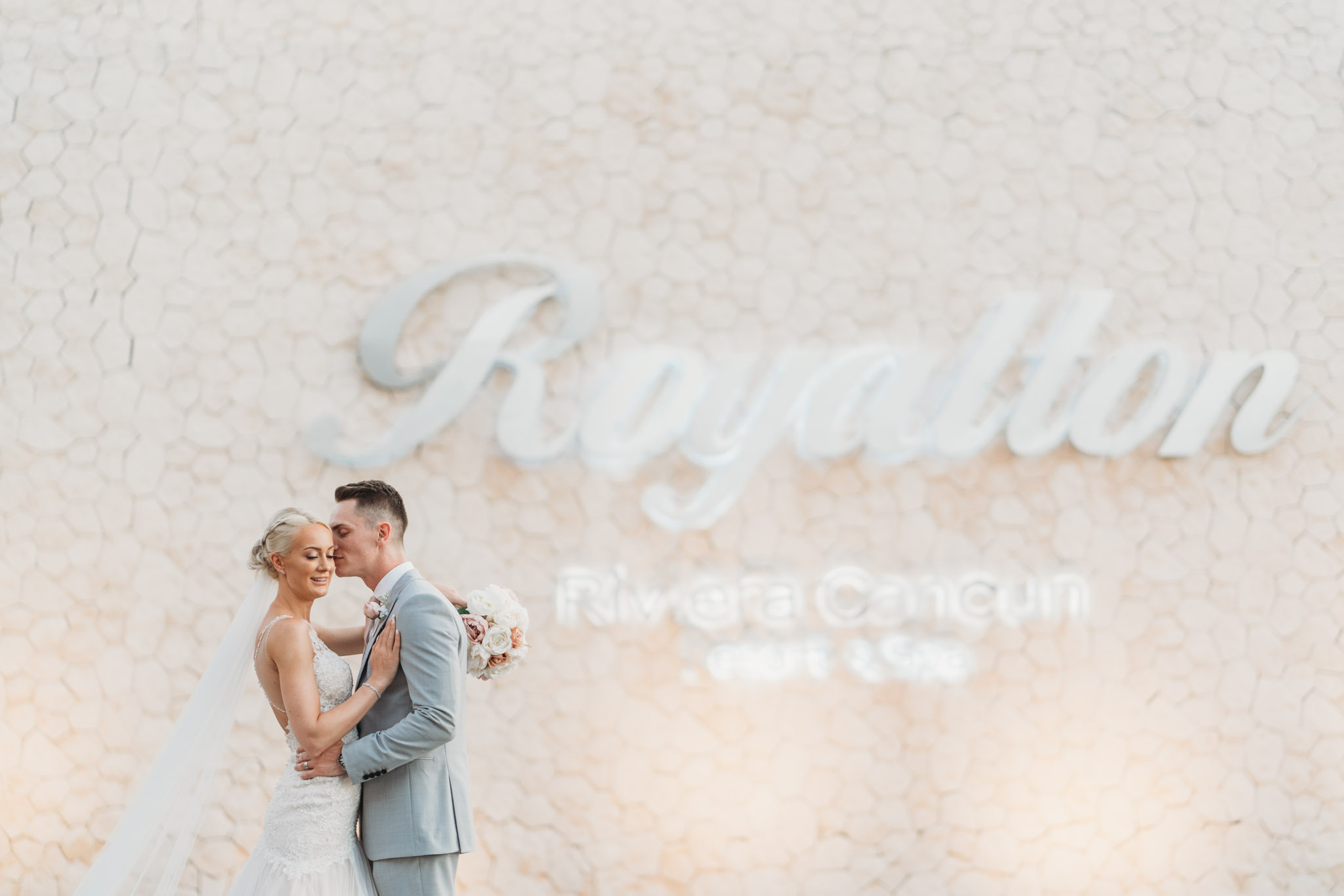 bride & groom photograph with the Royalton Riviera sign in the background at the hotel