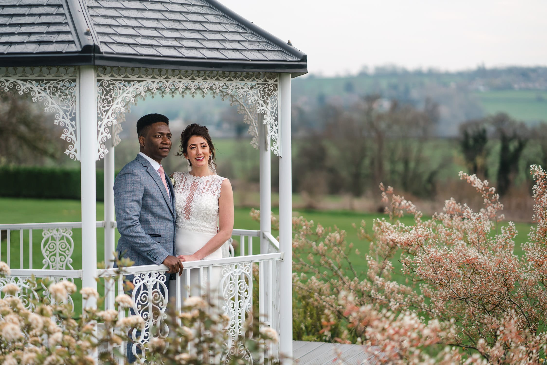 Wedding photograph of bride and groom in the bandstand at Shottle Hall