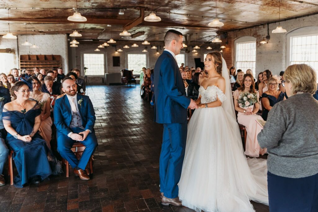 Wide photograph of wedding ceremony at West Mill. 