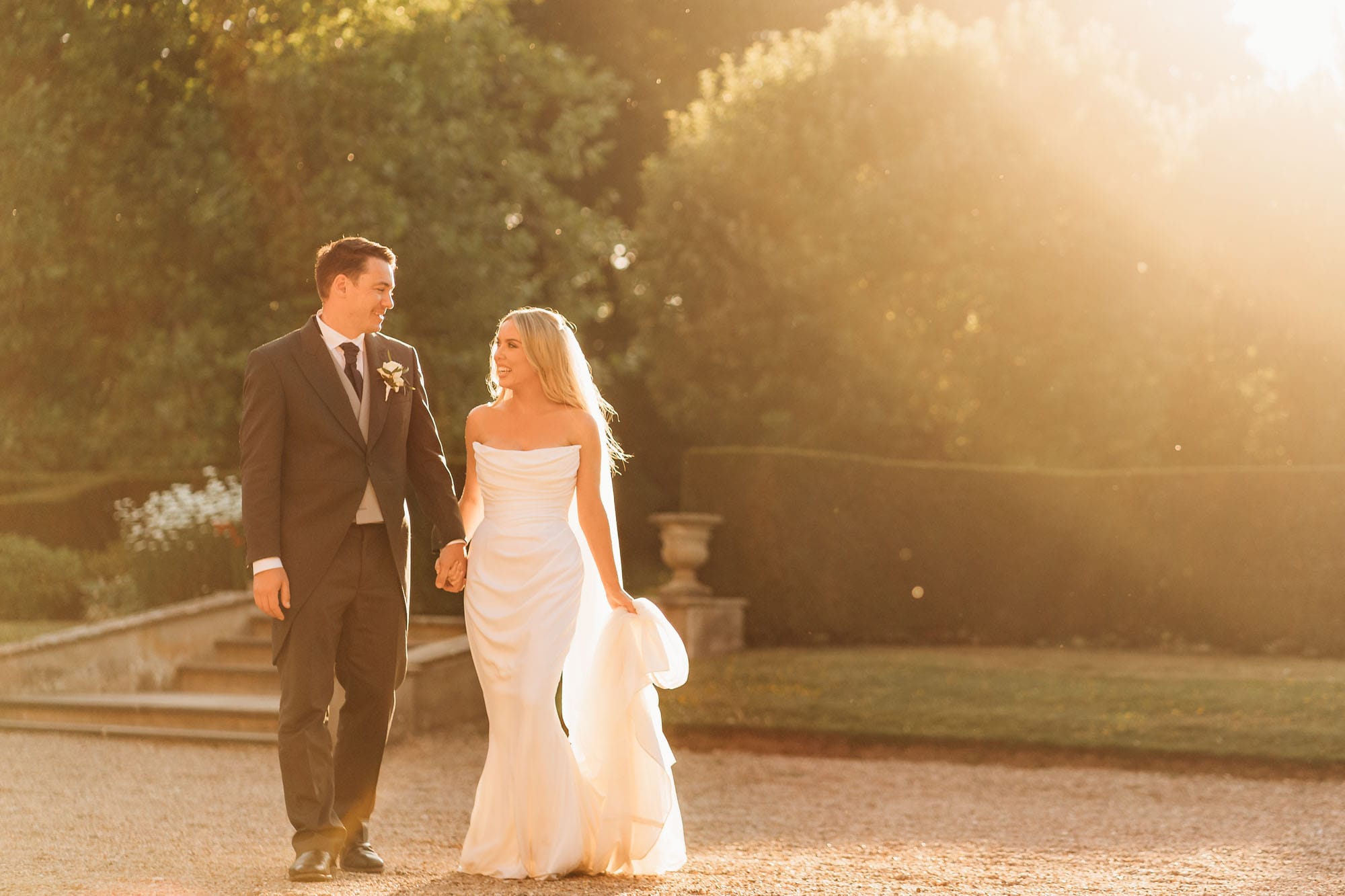 Bride and groom walking during golden hour at Norwood Park
