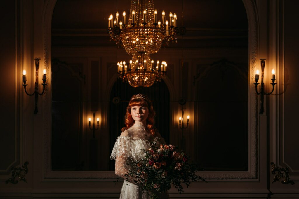 Beautiful bride stood inside holding bouquet at Ringwood Hall