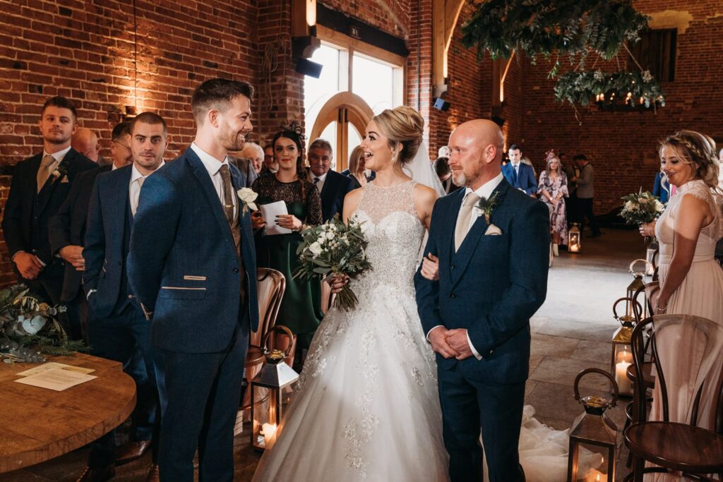 Bride has big smile on face as she meets her waiting groom at Hazel Gap Barn
